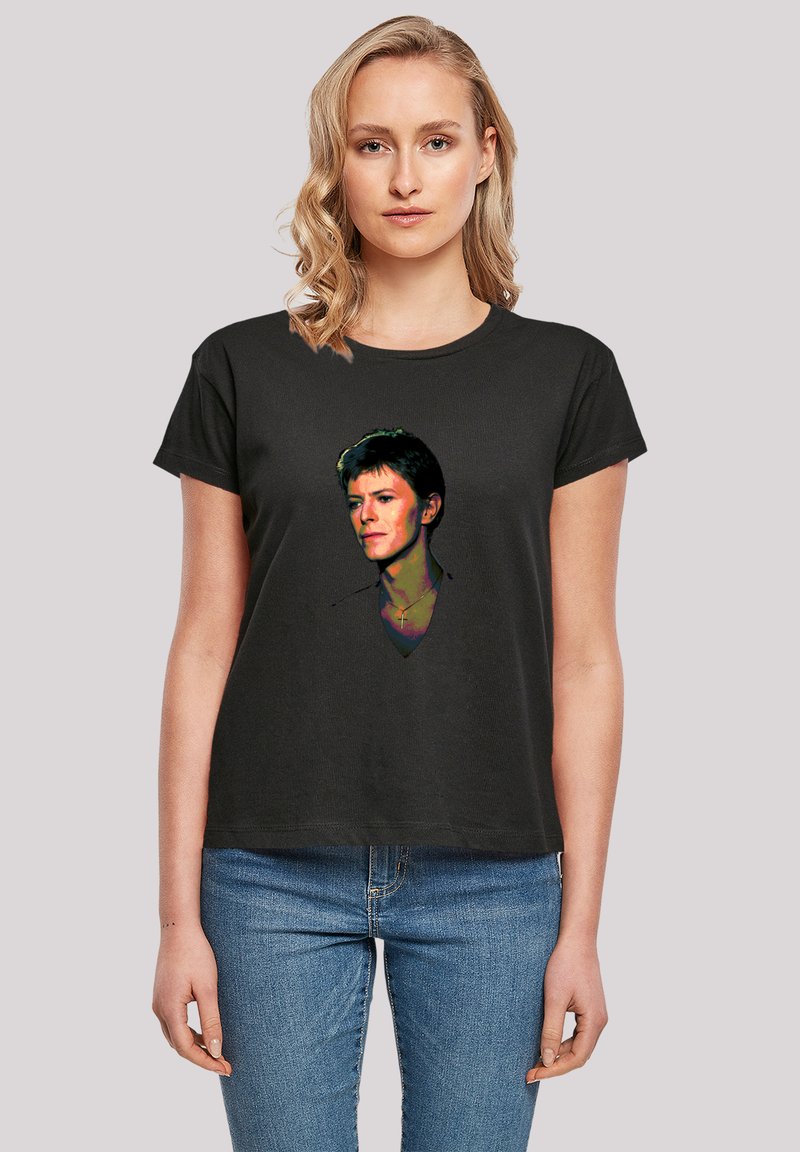 Black cotton t-shirt featuring a colorful graphic print of a male portrait on the front. Short sleeves and casual fit design.