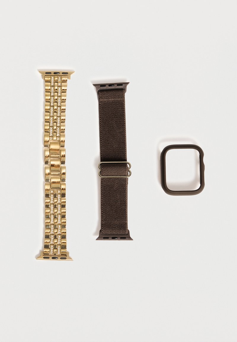 Deux bracelets de montre connectée, un en maillon métallique doré avec pierres incrustées et un en tissu tissé foncé avec boucle, ainsi qu'un cadre rectangulaire foncé pour montre connectée.