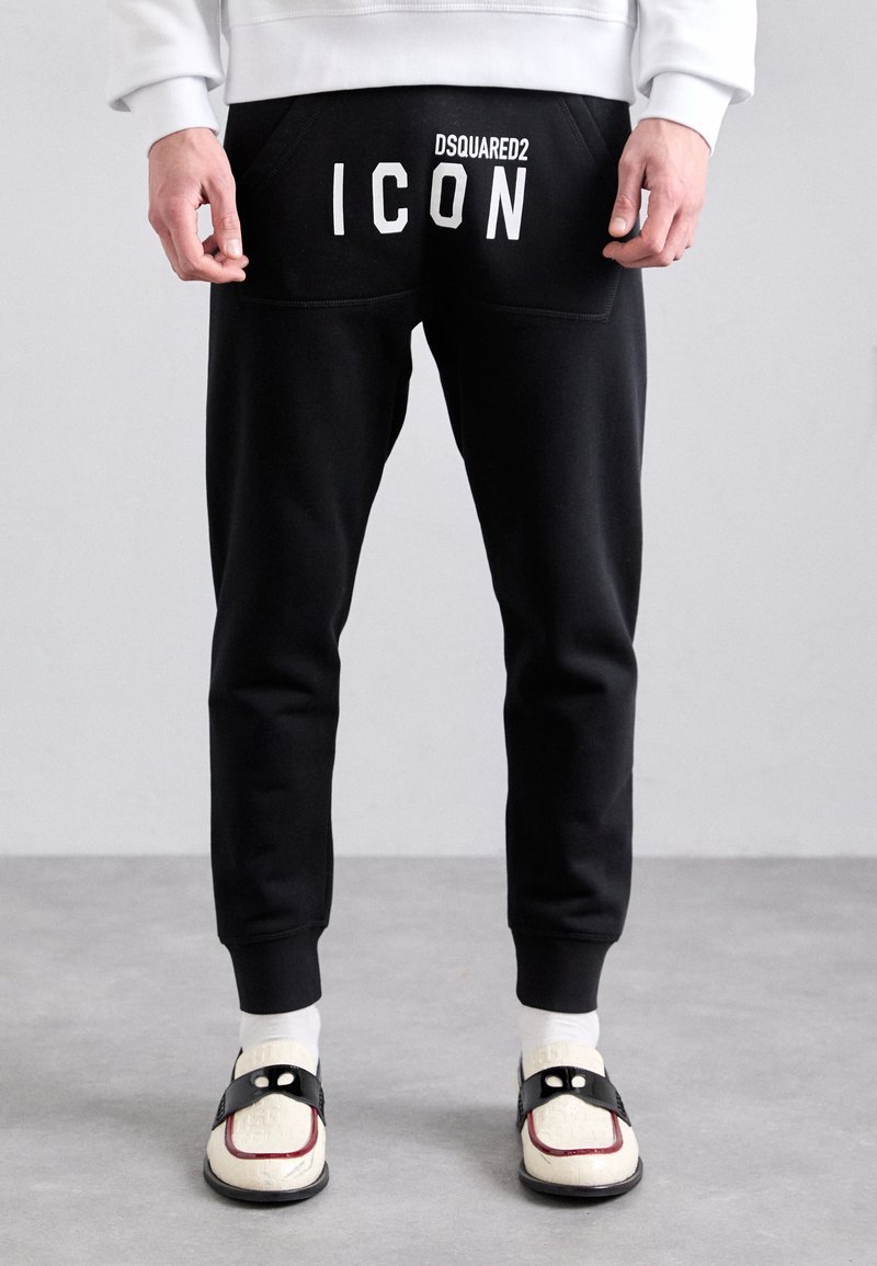 Sorte sweatpants med en slim fit, der har et hvidt "DSQUARED2 ICON" print på ryggen, elastisk talje og ribbede ankler.