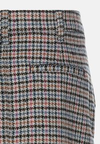 Hosen aus Wollgemisch mit einem mehrfarbigen Hahnentrittmuster in Blau, Schwarz, Orange und Pink, mit aufgesetzten Taschen und einer strukturierten Oberfläche.
