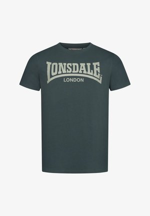 Dark green cotton t-shirt with short sleeves and a round neckline; features a large cream logo "Lonsdale London" across the chest.