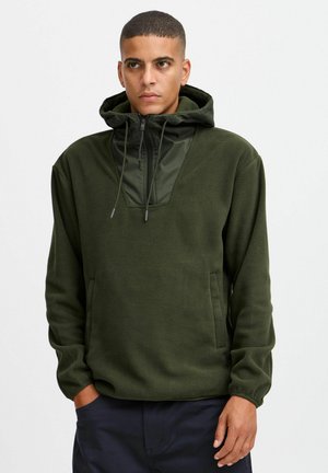 Olive green fleece hoodie with a zippered neck and a contrasting glossy panel. Features drawstrings and a kangaroo pocket.