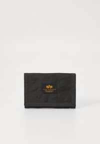 Black nylon wallet with a fold-over design, featuring a yellow logo patch and stitched edges. Textured fabric with a subtle pattern.