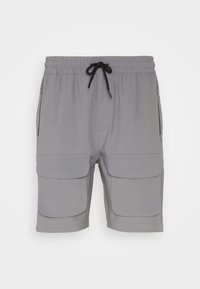 Šedé cargo šortky s elastickým pasem a šňůrkou, vybavené dvěma velkými předními kapsami a bočními kapsami na zip. Hladký materiál.