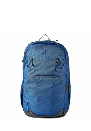 Mochila azul Deuter Cutogy con múltiples compartimentos con cremallera y una asa superior, mostrada sobre un fondo blanco liso.