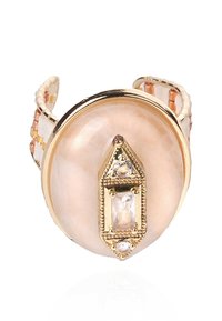 Gold-tone ring with a large, round peach stone featuring a decorative gold and crystal detail at the center and a beaded band.