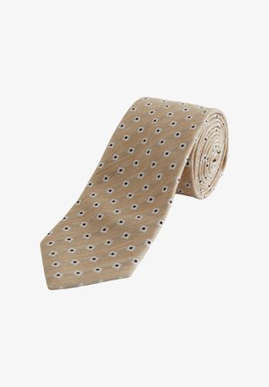 Beige nyakkendő, kis fehér négyzetekkel mintázva, amelyek apró sötét gyémánt alakzatokat tartalmaznak, fehér háttér előtt feltekerve.