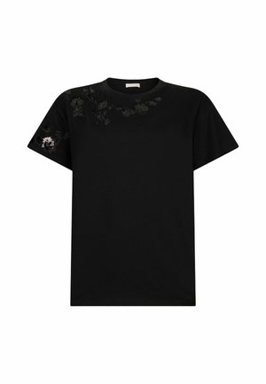 T-shirt nero in cotone con maniche corte. Vanta un'intricata ricamo floreale nero con dettagli sulle spalle. Collo a giroclassico.