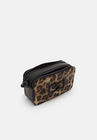 Leopard print cosmetic bag with a black leather trim, rectangular shape, dual zipper closure, and a flat black accent on the front.