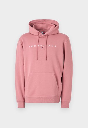 Vaaleanpunainen huppari, joka on valmistettu pehmeästä kankaasta ja jossa on kengurupocket, nyöritettävä huppu ja "TOMMYJEANS" -logo valkoisena rinnassa.