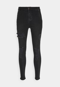 Jeans skinny negros de mezcla de denim con áreas desgastadas y bordes deshilachados en las rodillas. Presenta un diseño clásico de cinco bolsillos y cierre frontal con botón.