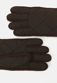 Brown quilted gloves with a smooth texture, featuring five individual fingers and dark stitching accents along the edges.