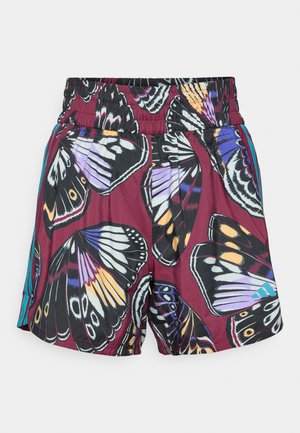Un short orné d'un imprimé papillon vibrant dans des nuances de violet, noir et orange. Taille élastique avec de subtils accents latéraux en turquoise.
