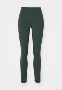 Leggings de color verde oscuro con una cinturilla alta y ancha, fabricados con una tela suave y elástica. Las piernas son ajustadas sin costuras visibles.
