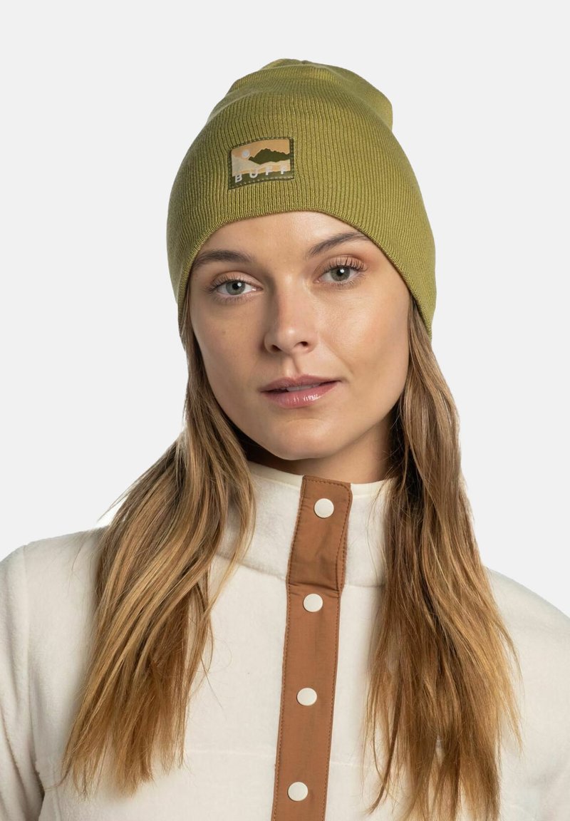 Olive green knitted beanie with a ribbed texture, featuring a rectangular patch with mountain graphics and the word "BUFF."