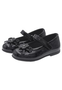 Svarta lackläders Mary Jane-skor med rund tå, blommiga dekorationer och ett justerbart rem.