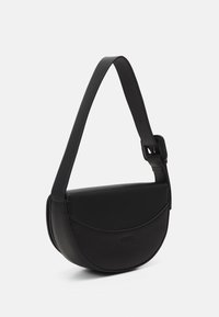 Sac d'épaule noir en forme de demi-lune avec une large sangle réglable et une fermeture à rabat sur fond uni.