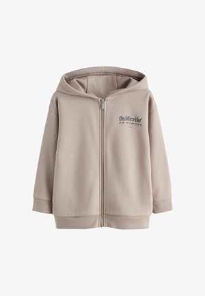 Smėlio spalvos užtraukiama su gobtuvu džemperis su kišenėmis priekyje, rifliuotais rankogaliais ir apačia, gobtuvu bei ant kairės krūtinės užrašytu žodžiu „Prenumeruoti“.