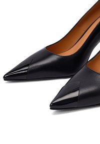 Décolleté neri in pelle con punta affusolata e accenti neri lucidi. Le scarpe presentano un design elegante e una texture liscia per un aspetto moderno.