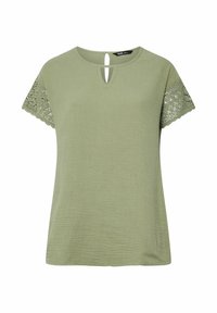 Olivgrön kortärmad topp med en strukturerad yta, med en nyckelhålsringning och spetsdetaljer på ärmarna för extra stil.