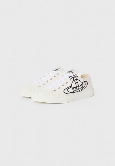 White canvas sneakers with black graphic design of a spaceship. Features white laces, rubber sole, and metal eyelets.