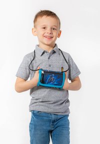 Small blue crossbody bag with a zipper, featuring a black design of a rider on a motorcycle. Worn by a child in a gray polo shirt.