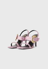 Pink glitter sandals with gold hardware, open-toe design, and studded accents. Features a slender heel and adjustable ankle strap.