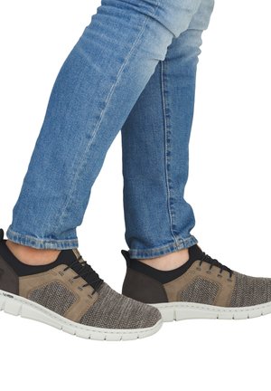 Herren-Sportsneaker mit einem Obermaterial aus grauem Mesh, beigen Akzenten, schwarzen Details und einer weißen Gummisohle. Strukturiertes Design mit Schnürsenkeln.