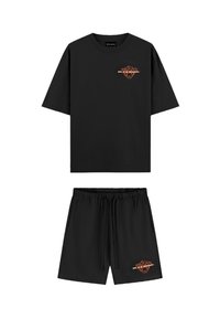 Zwart t-shirt en shorts set in katoen, met een ronde halslijn, korte mouwen, elastische tailleband en een oranje grafisch detail.
