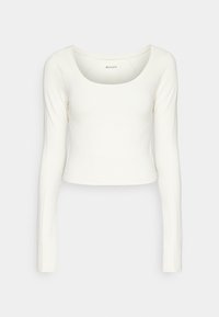 Biała, długosleeve crop top o zaokrąglonym dekolcie. Wykonany z gładkiego, elastycznego materiału i z minimalnymi detalami szwów.