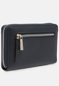 Navy leather wallet with a textured surface, featuring a silver zipper and pull tab, designed with an exterior pocket for additional storage.