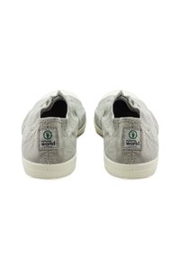 Szürke vászon slip-on cipők texturált felülettel, fehér gumitalppal és logócímkével a saroknál. Klasszikus, minimalista dizájn.