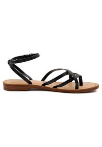 Sandal in pelle nera con più cinturini sottili e cinturino alla caviglia, dotata di suola piatta e soletta beige, progettata per un uso casual.