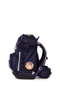 Navy backpack with starry pattern, adjustable straps, reflective accents, and two side pockets. Features a circular decorative patch.