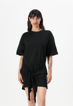 Black short-sleeve dress with a knotted front detail. Made of soft fabric, featuring a round neckline and small logo accent near the neck.