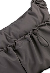 Dark gray padded bag featuring a gathered design with an adjustable drawstring. The fabric appears smooth with a slight sheen.