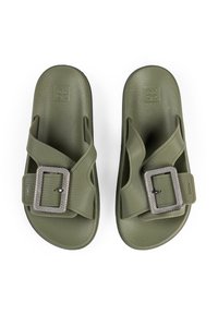 Olive green slide sandals made of soft, textured material with a wide strap and square metallic buckle. Flat soles with grip pattern.