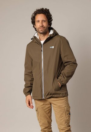 Olijfgroene hoodie-jack met een witte rits en elastische manchetten. Heeft een zachte binnenvoering en een klein logo-opdruk op de borst.