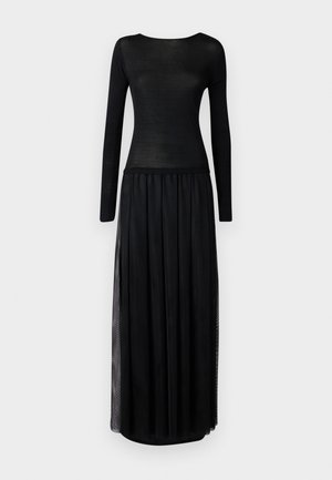Black dress with a fitted long-sleeve top made of sheer material, transitioning to a flowing maxi skirt with side slits.