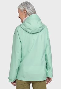 Hellgrüne wasserdichte Jacke mit Kapuze, die eine glatte Textur und verstellbare Bündchen aufweist, von hinten gezeigt.