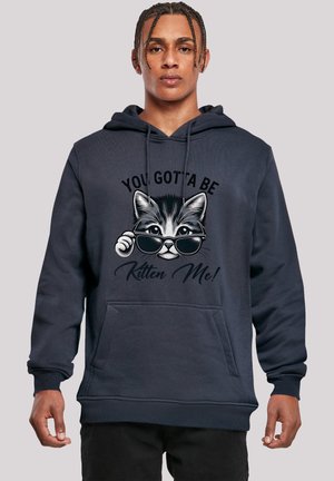 Navy hoodie with a front pocket, featuring a cat graphic with sunglasses and the text "You Gotta Be Kitten Me!" in black. Soft texture.