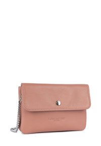 Pink leather handbag with a flap closure, metallic snap button, embossed branding, and a chain strap. Smooth texture and compact design.