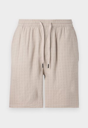 Beige, strukturerte shorts med elastisk midje og snor. Har et subtilt rutemønster og løs passform. Ingen lommer synlige.