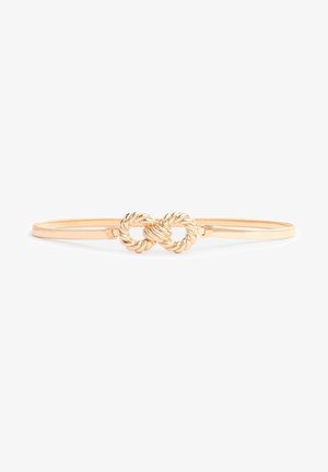Ceinture fine en or avec un double nœud torsadé au centre, présentant une finition lisse et brillante sur fond blanc.