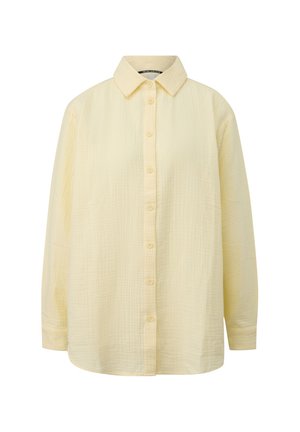 Langärmliges, blassgelbes, strukturiertes Baumwollhemd mit durchgehender Knopfleiste und klassischem spitzem Kragen.