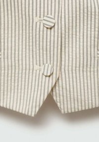 Lightweight cream fabric with vertical black stripes. Features two round buttons, one partially visible, on the left side. Textured finish.