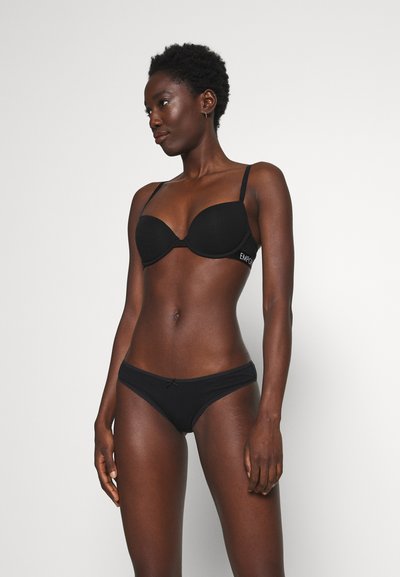 Black padded bra with adjustable straps and embroidered detail. Matching low-rise bikini with a satin bow accent and stretchy fabric.