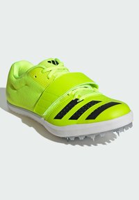 Scarpe da ginnastica brillanti di colore verde neon con una tomaia in rete testurizzata, accentuate da dettagli neri e una striscia in velcro. Presentano punte in gomma per una maggiore aderenza.