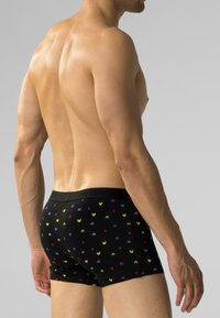 Czarne bawełniane bokserki z kolorowym wzorem przedstawiającym obcych, elastycznym pasem i dopasowanym krojem, widok z boku i z tyłu.