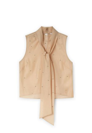 Blouse sans manches beige avec un col noué, ornée de petits embellissements scintillants, fabriquée en tissu léger.